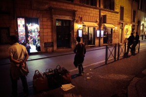 Purse vendors and businessmen in Rome