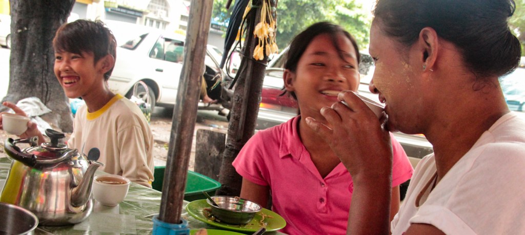People enjoying street food in Yangon, Myanmar